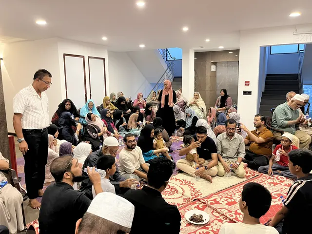 The Dar Us Salam family sharing a meal.